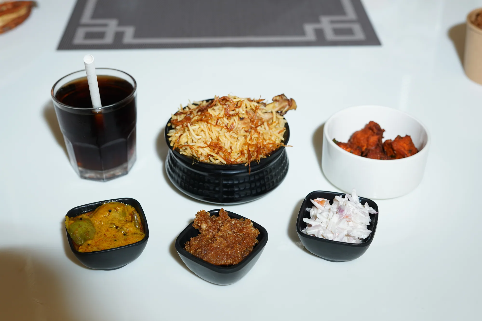 A complete biryani meal prepared with accompaniments