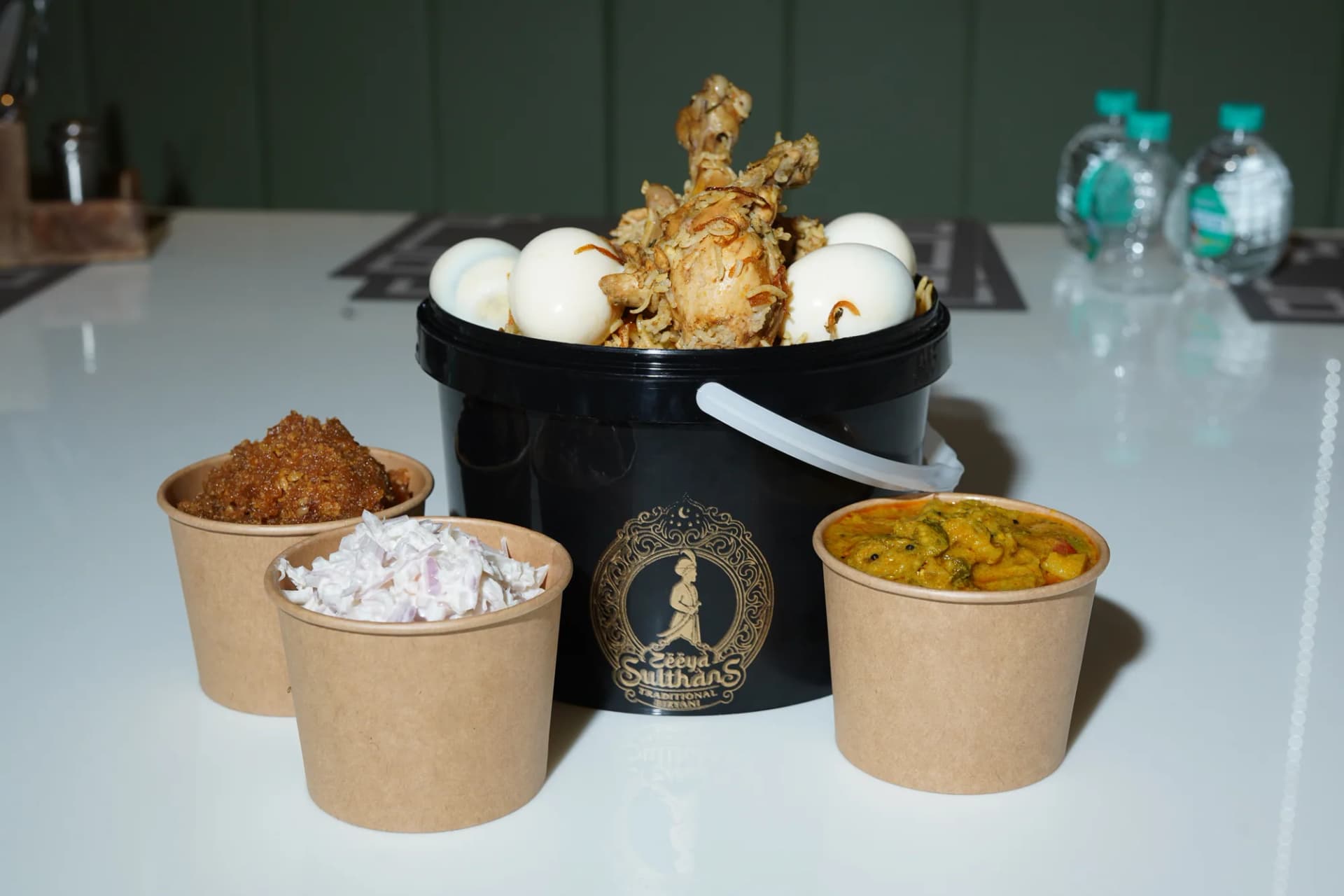 A generous Zeeya Sulthans biryani bucket served with eggs and accompaniments
