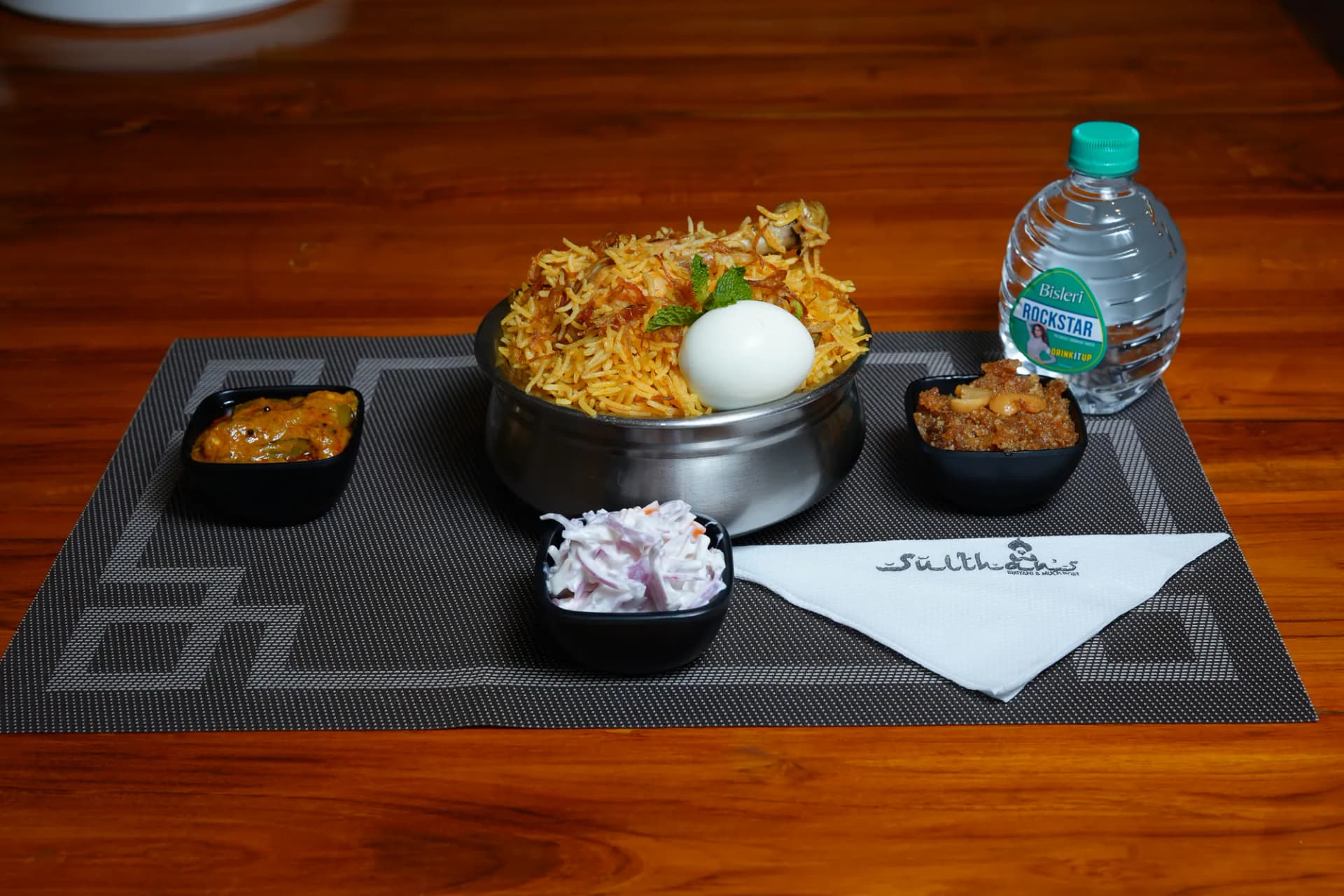 Zeeya Sulthans dum biryani served with egg, raita and accompaniments